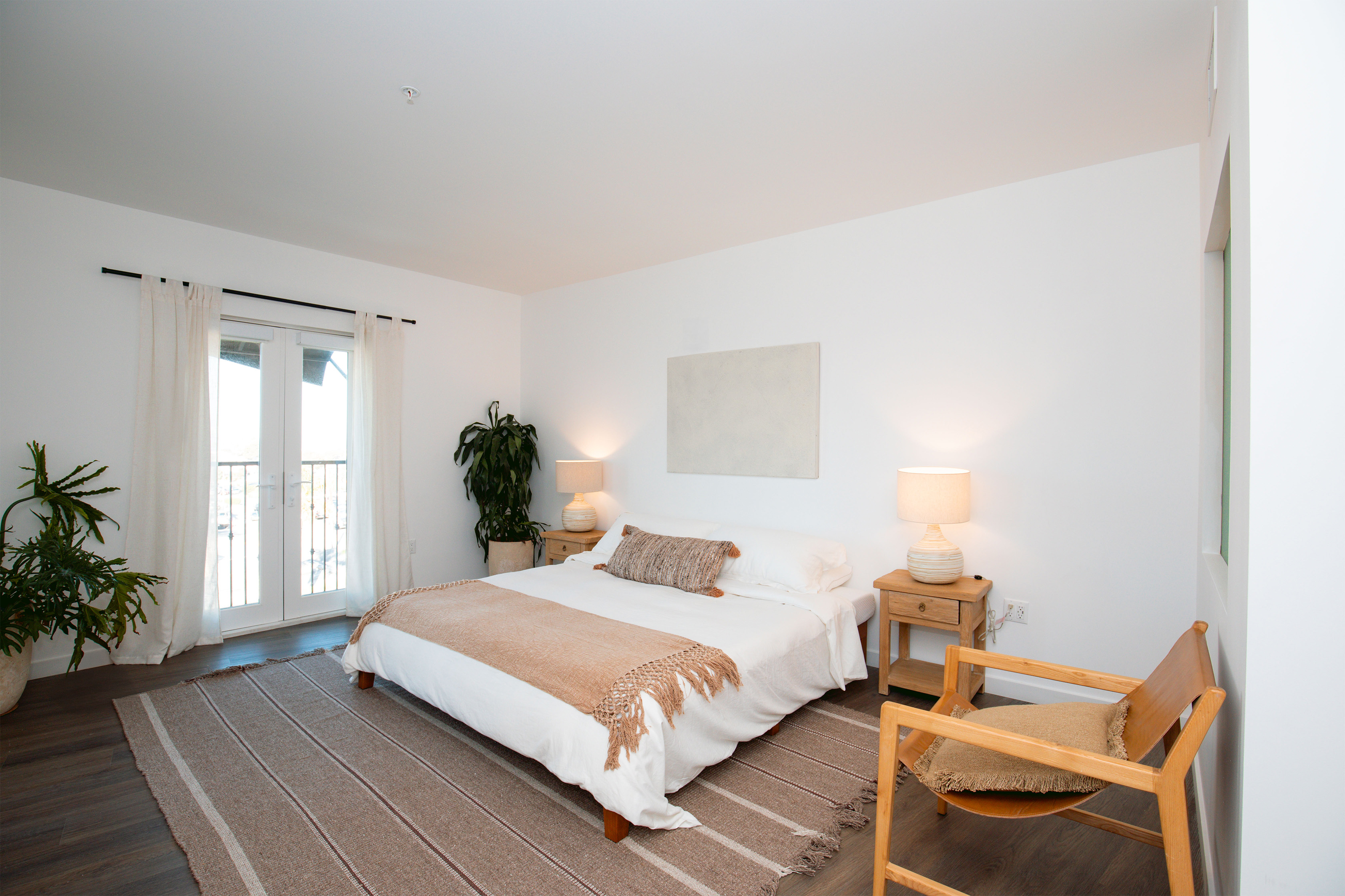 bedroom with a queen bed and balcony window